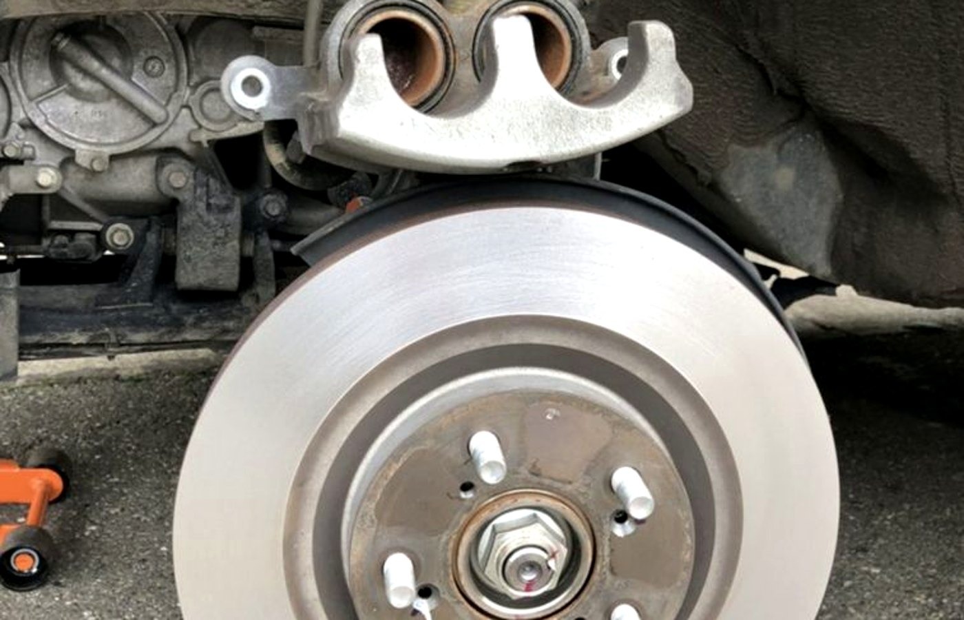 Rotor and bracket ready for pads at a Lubbock brake service